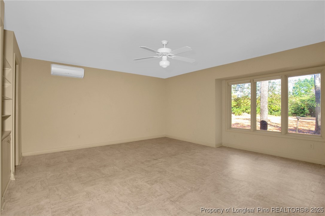549 Rainforest Road Hope Mills, NC 28348 - Photo 11 of 40 an empty room with a window and a ceiling fan