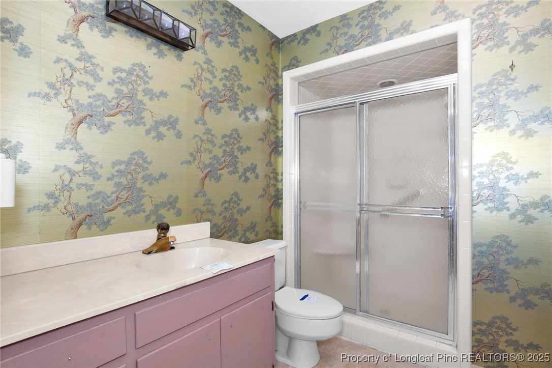 549 Rainforest Road Hope Mills, NC 28348 - Photo 13 of 40 a bathroom with a sink a toilet and shower