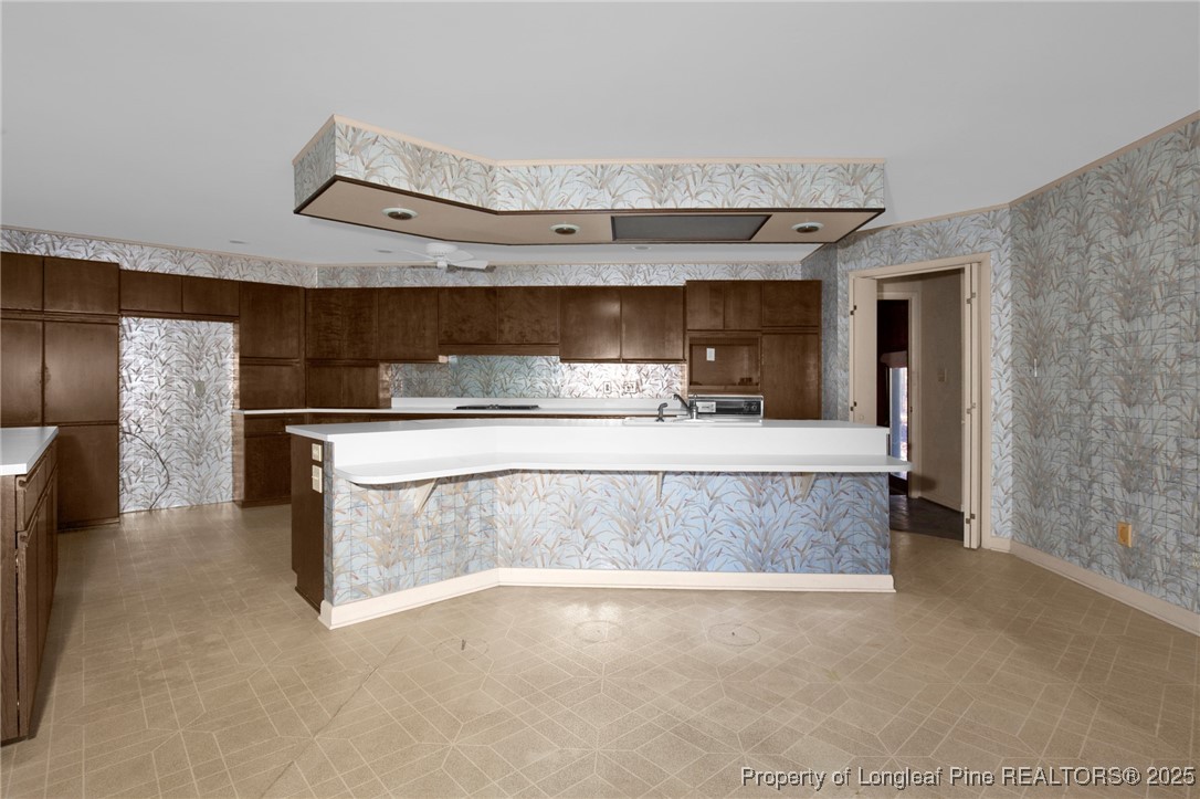 549 Rainforest Road Hope Mills, NC 28348 - Photo 6 of 40 a living room with stainless steel appliances kitchen island a large counter top and a fireplace