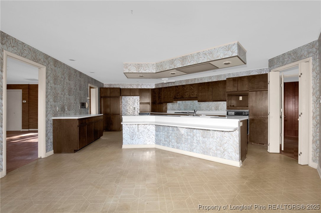 549 Rainforest Road Hope Mills, NC 28348 - Photo 7 of 40 a large kitchen with a large counter top stainless steel appliances and cabinets