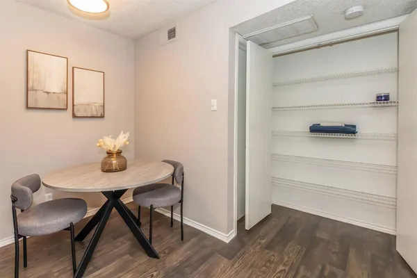 a view of a workspace with furniture and wooden floor