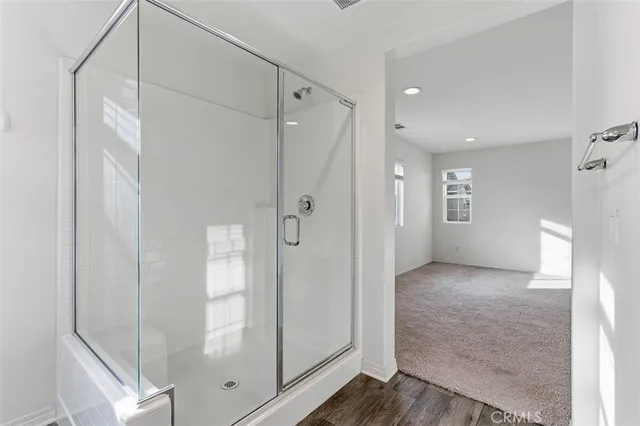 a view of a bathroom with a glass door shower