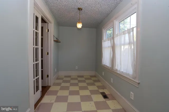 a view of a bathroom with a black and white checkered floor
