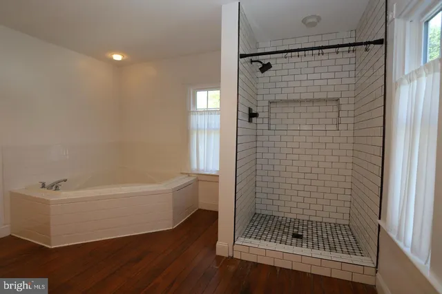a bathroom with a bathtub and a shower