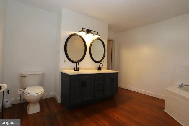 a bathroom with a toilet a sink and a mirror