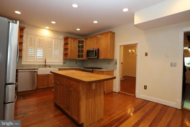 a kitchen with a refrigerator and a sink