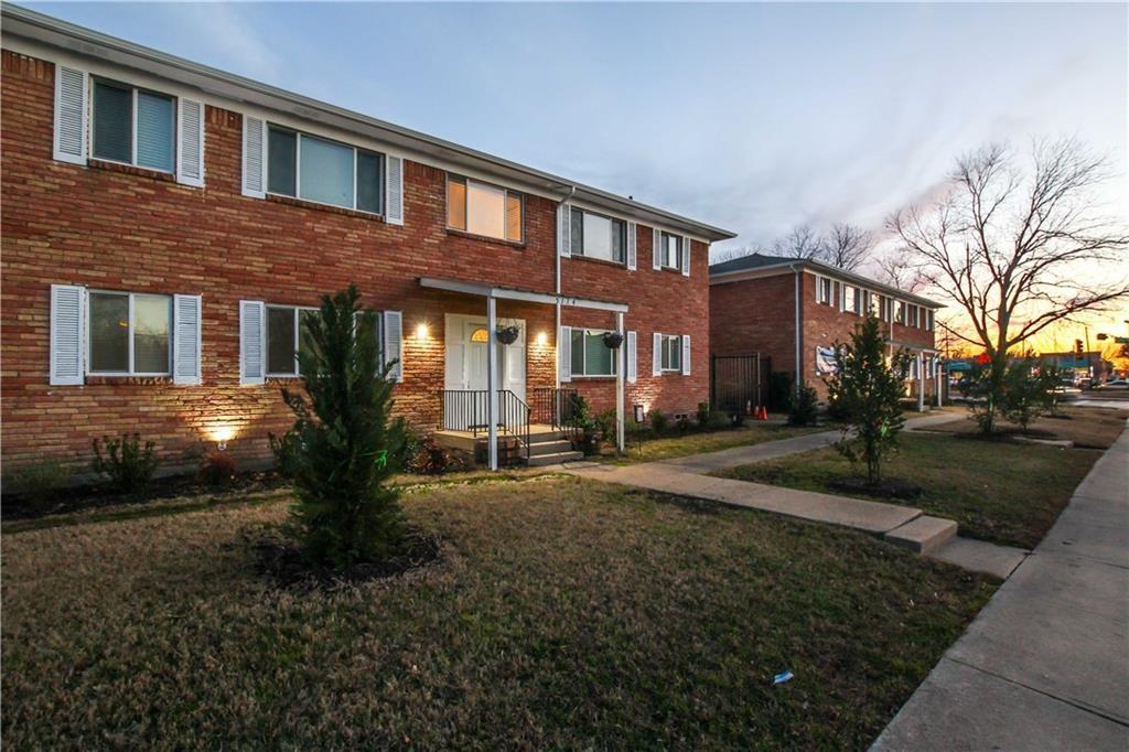 Traditional-style home with a front yard and brick siding