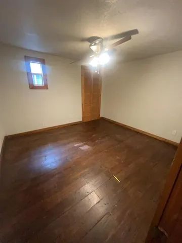 a kitchen with a sink a stove cabinets and wooden floor