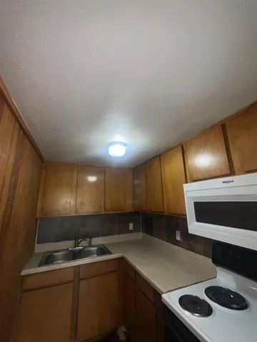 a bathroom with a sink mirror vanity and toilet