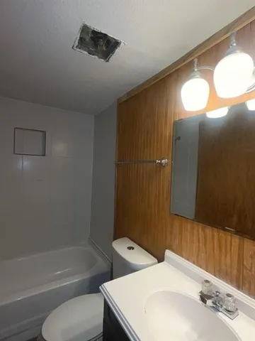 a bathroom with a sink mirror and vanity