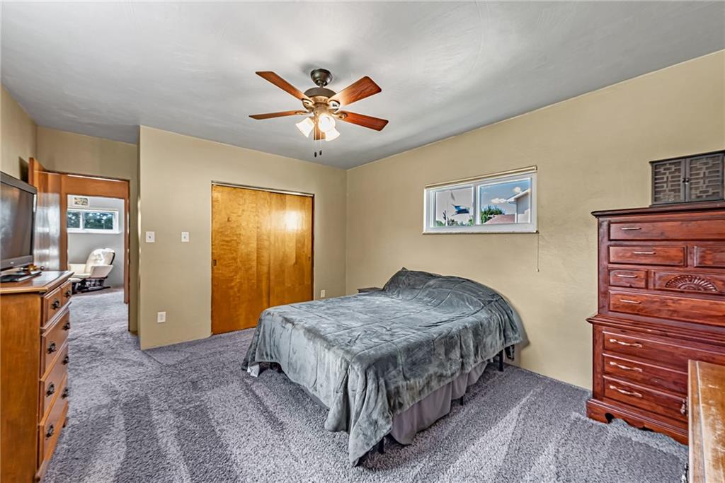 2112 Claridge Elliott Road Claridge, PA 15623 - Photo 12 of 25 a spacious bedroom with a bed and a chandelier