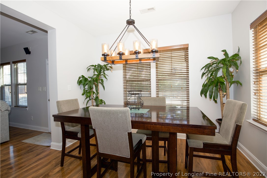 747 Sun Road Aberdeen, NC 28315 - Photo 14 of 48 a view of a dining room with furniture window and wooden floor