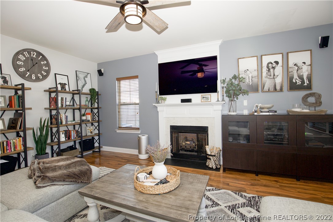 747 Sun Road Aberdeen, NC 28315 - Photo 17 of 48 a living room with furniture a flat screen tv and a fireplace