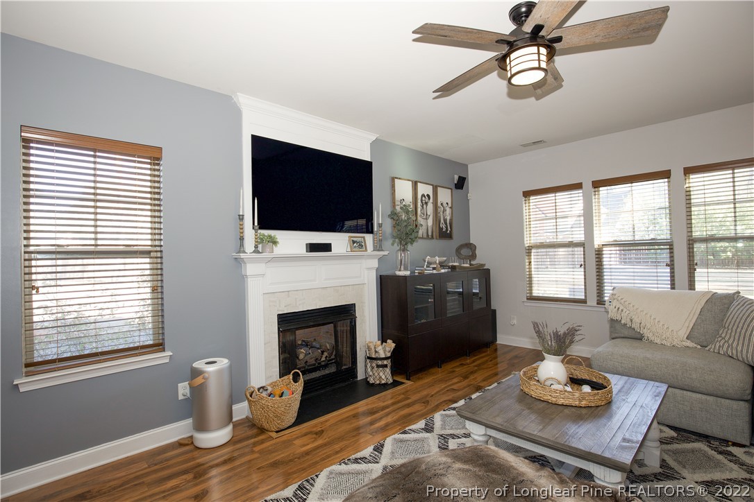 747 Sun Road Aberdeen, NC 28315 - Photo 18 of 48 a living room with furniture a fireplace and a flat screen tv