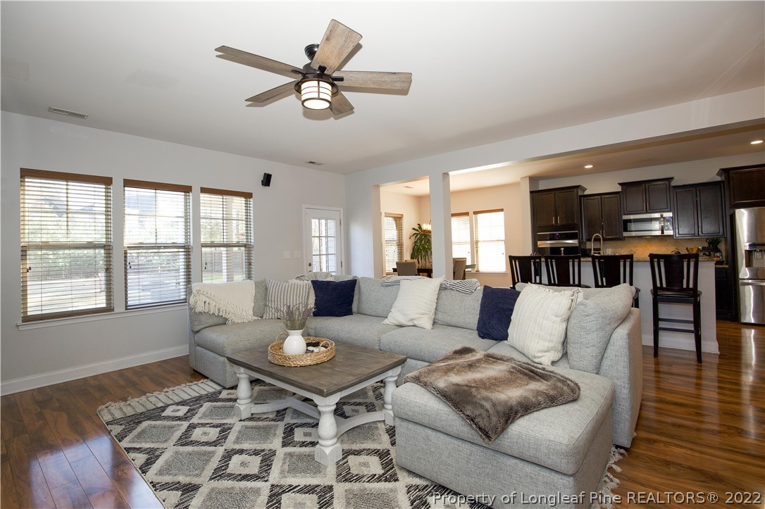 747 Sun Road Aberdeen, NC 28315 - Photo 19 of 48 a living room with furniture a rug potted plant and a window