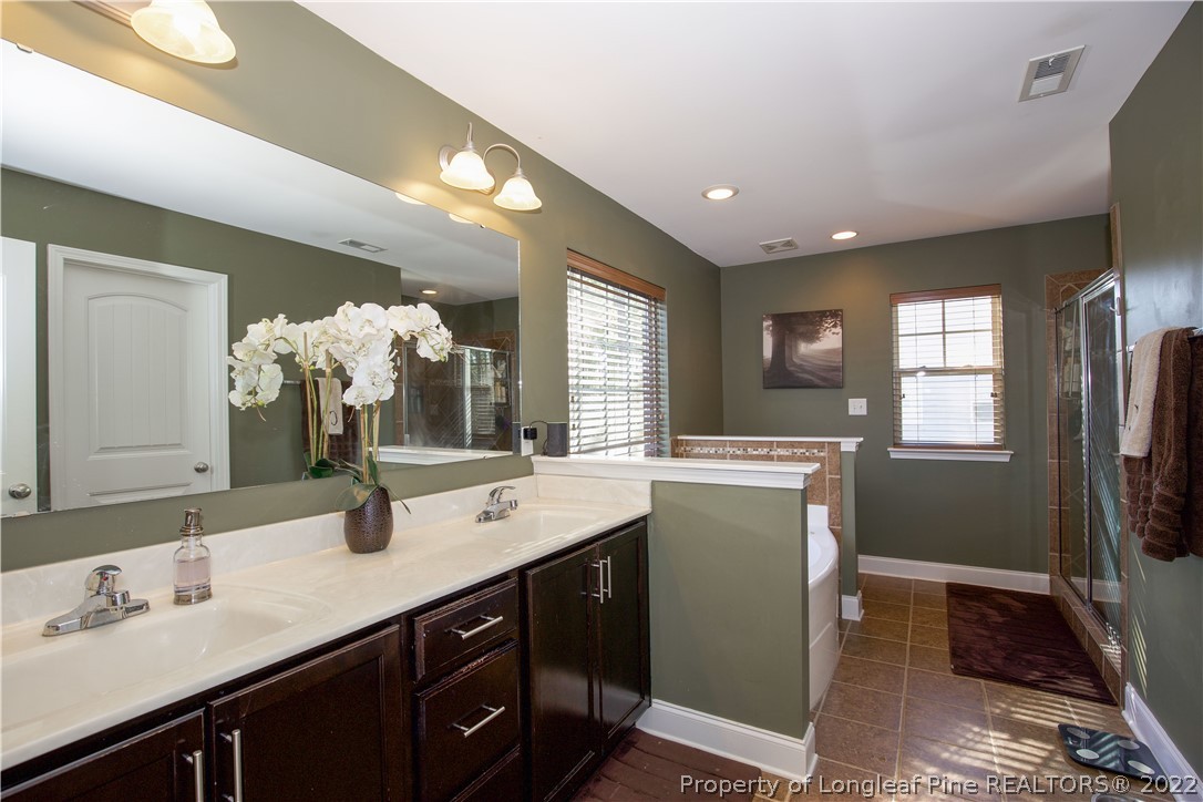 747 Sun Road Aberdeen, NC 28315 - Photo 24 of 48 a bathroom with a double vanity sink and a mirror