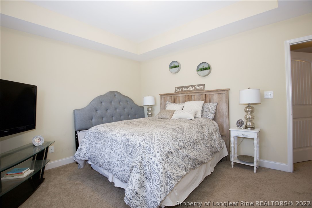 747 Sun Road Aberdeen, NC 28315 - Photo 28 of 48 a bedroom with a bed and a flat screen tv