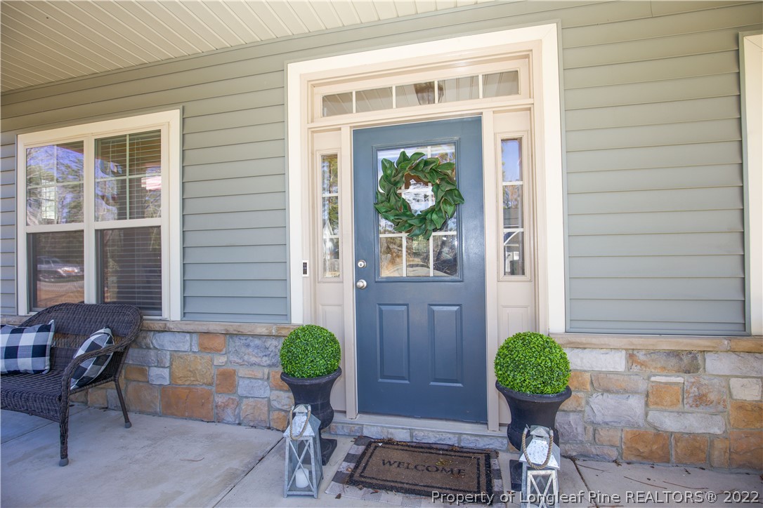 747 Sun Road Aberdeen, NC 28315 - Photo 3 of 48 a view of a entryway door of the house with outdoor seating