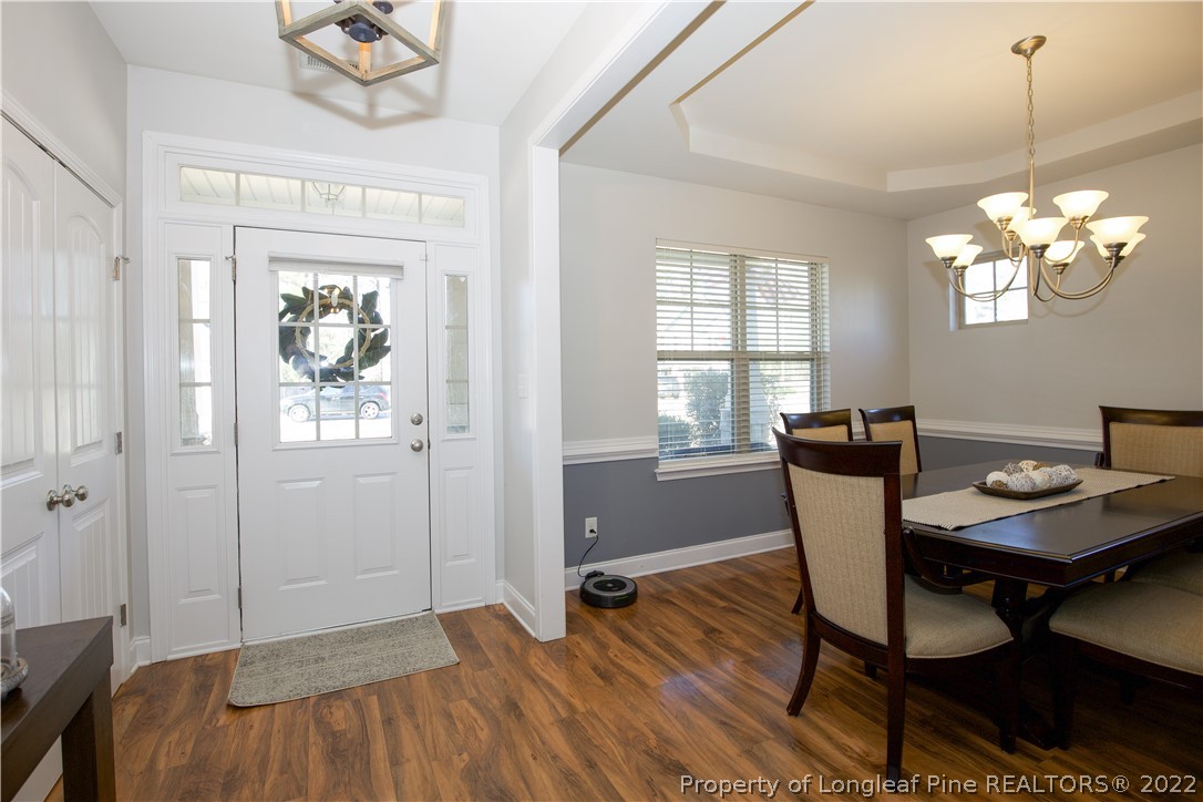 747 Sun Road Aberdeen, NC 28315 - Photo 5 of 48 a view of a dining room with furniture and wooden floor