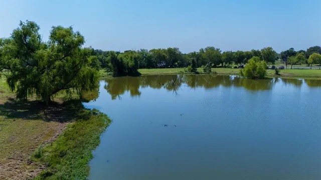 a view of a lake with houses in the back