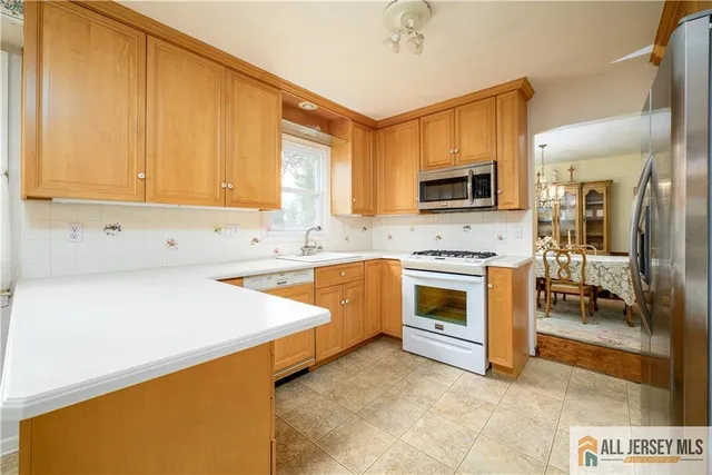 a kitchen with stainless steel appliances a stove sink and microwave