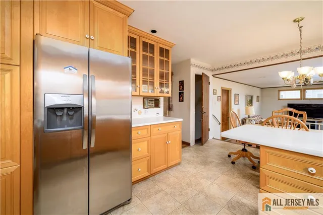 a kitchen with refrigerator and table