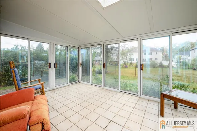 a bedroom with furniture and a floor to ceiling window