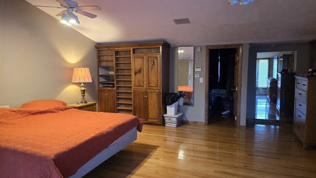 64 Village Street Millis, MA 02054 - Photo 16 of 37 a bedroom with a bed and a chandelier