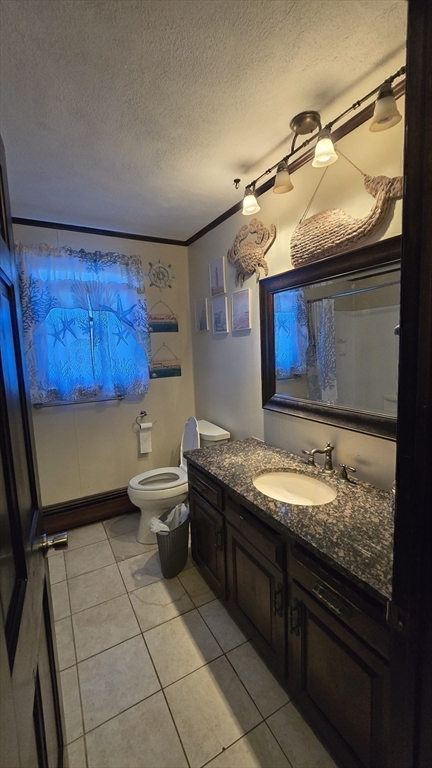 64 Village Street Millis, MA 02054 - Photo 28 of 37 a bathroom with a granite countertop sink a toilet and a mirror