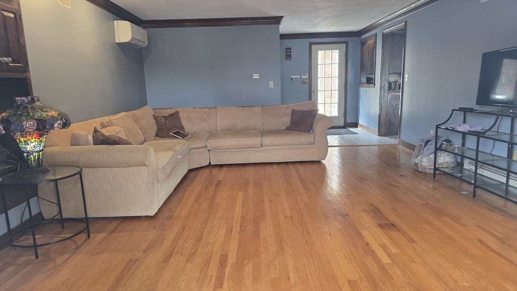 64 Village Street Millis, MA 02054 - Photo 5 of 37 a living room with furniture and a wooden floor