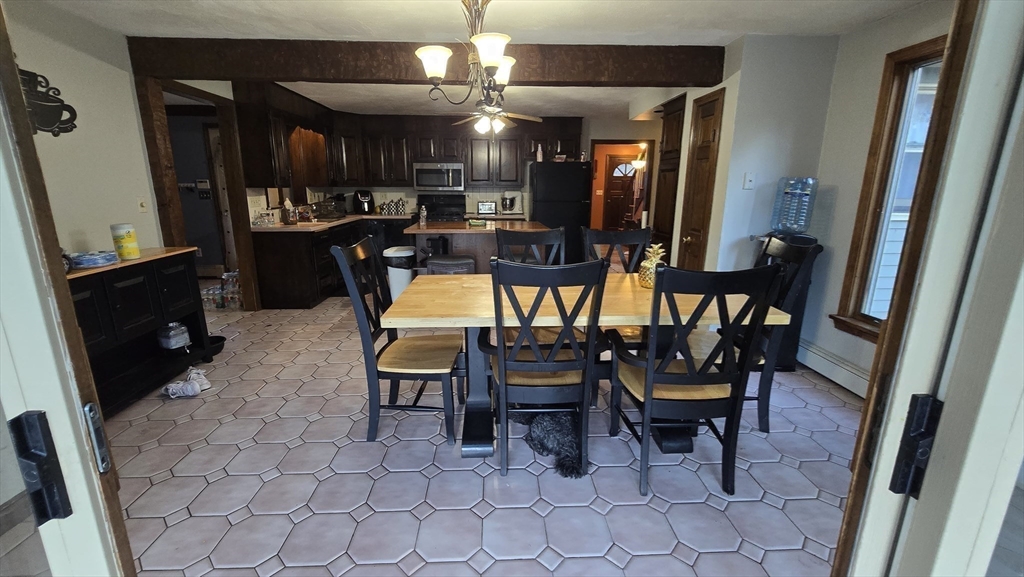 64 Village Street Millis, MA 02054 - Photo 8 of 37 a dining room with furniture and a chandelier