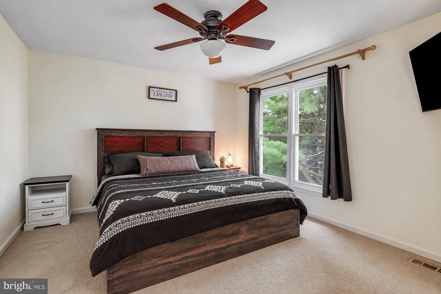 17303 Buehler Road Olney, MD 20832 - Photo 7 of 14 a bedroom with a bed and a tv
