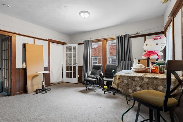 a view of a livingroom with workspace and a window