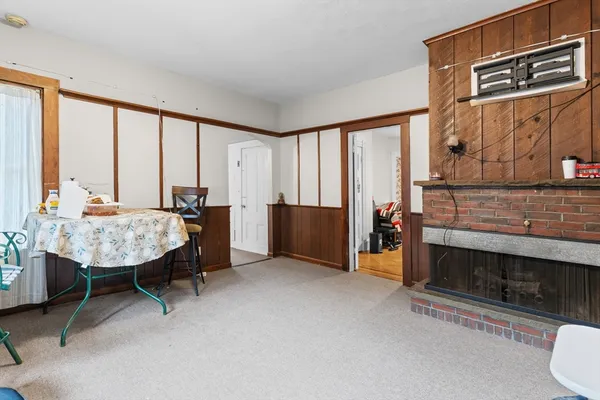 a living room with furniture a window and a fireplace
