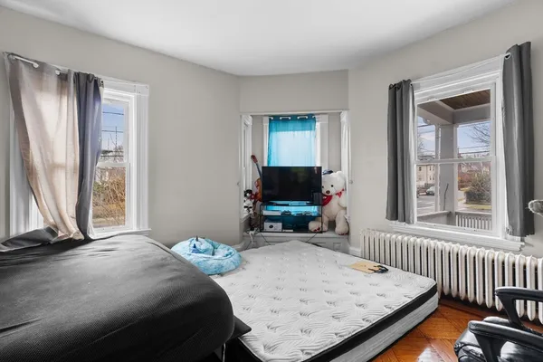 a bedroom with a bed and flat screen tv