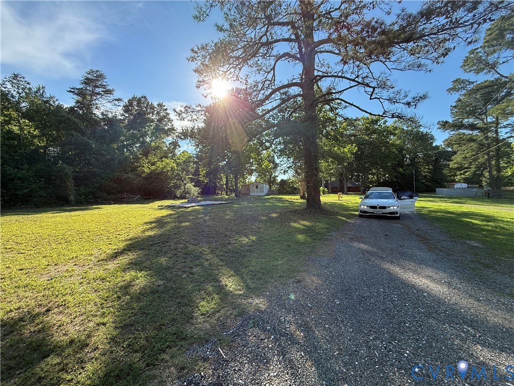 88 Seahawk Road Urbanna, VA 23175 - Photo 9 of 16 Spacious lot with mature trees, a gravel driveway,