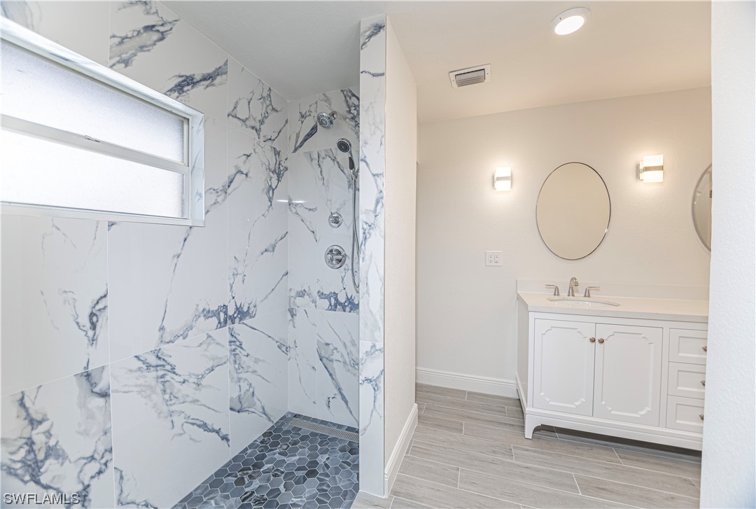 1753 Club House Road North Fort Myers, FL 33917 - Photo 15 of 24 a bathroom with a sink a mirror and a shower
