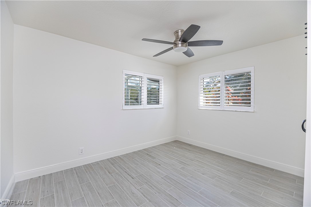 1753 Club House Road North Fort Myers, FL 33917 - Photo 20 of 24 a view of empty room with wooden floor and fan