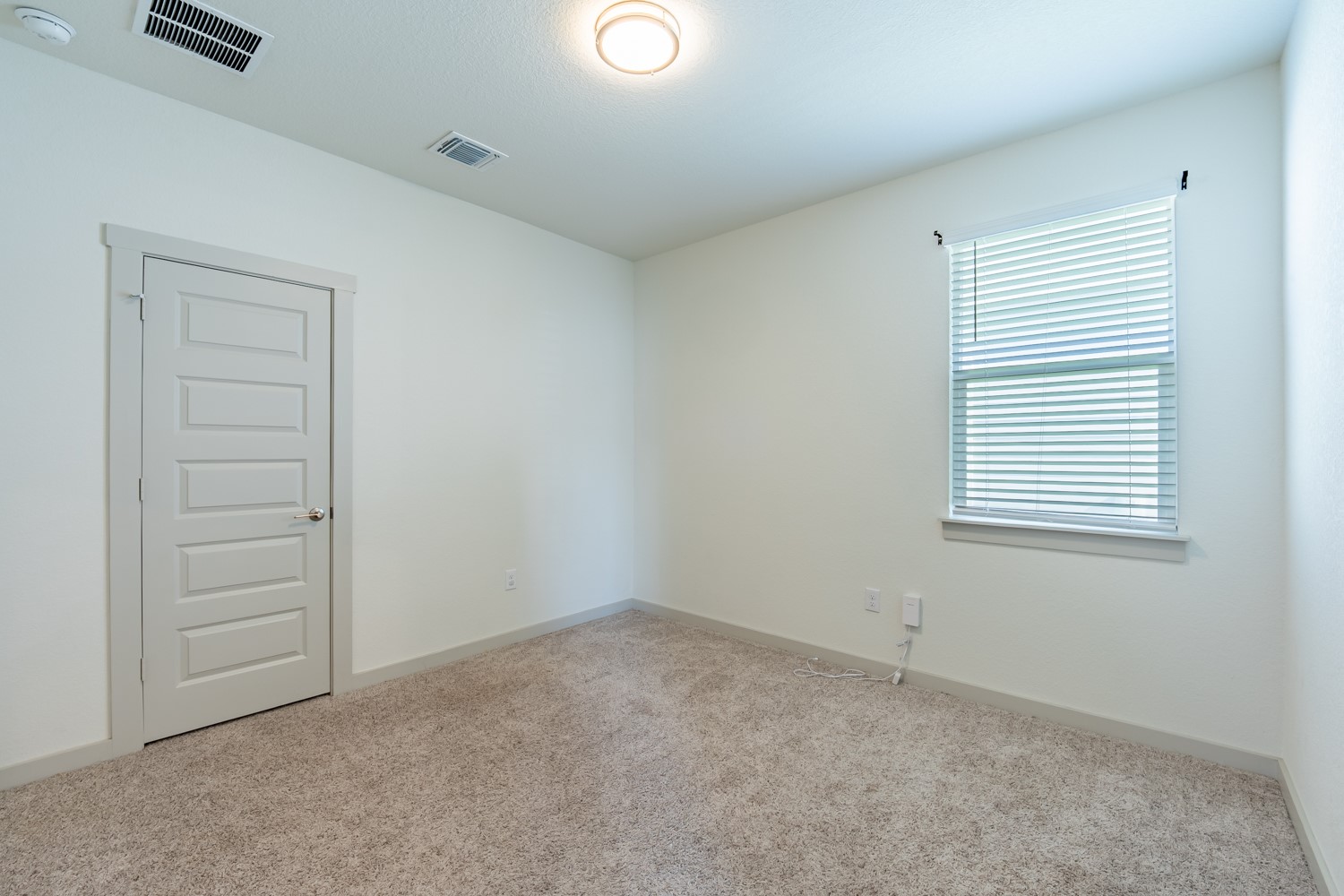 10801 Meris Lane Austin, TX 78754 - Photo 14 of 18 A well-proportioned bedroom with ample natural light, soft carpeting, and a clean, modern aesthetic.