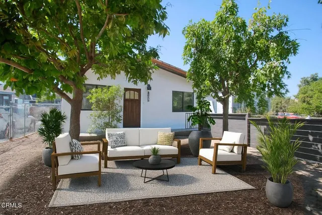 a view of a patio with couches chairs and a potted plant