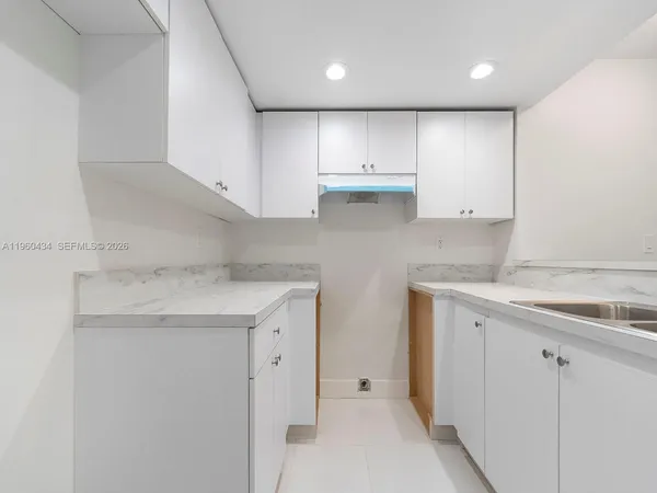 a kitchen with cabinets and a stove