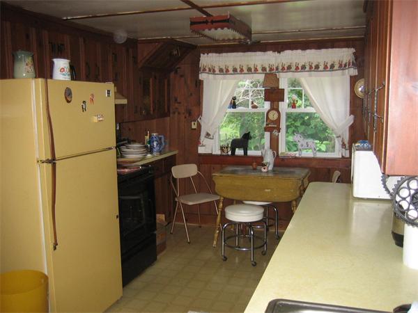 107 West Millbury Road Sutton, MA 01590 - Photo 13 of 26 a kitchen with a refrigerator and a table
