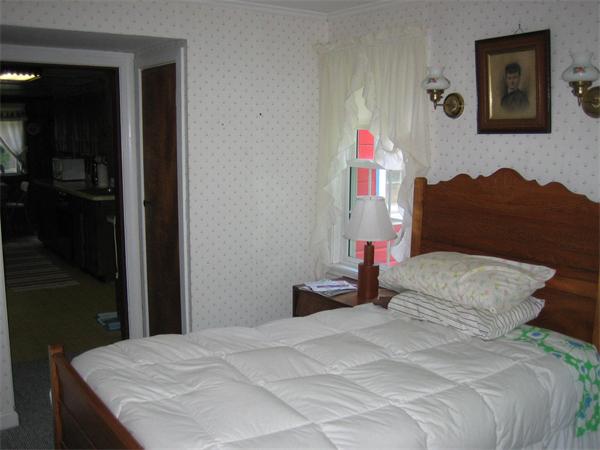 107 West Millbury Road Sutton, MA 01590 - Photo 16 of 26 a bedroom with a bed and a painting on the wall