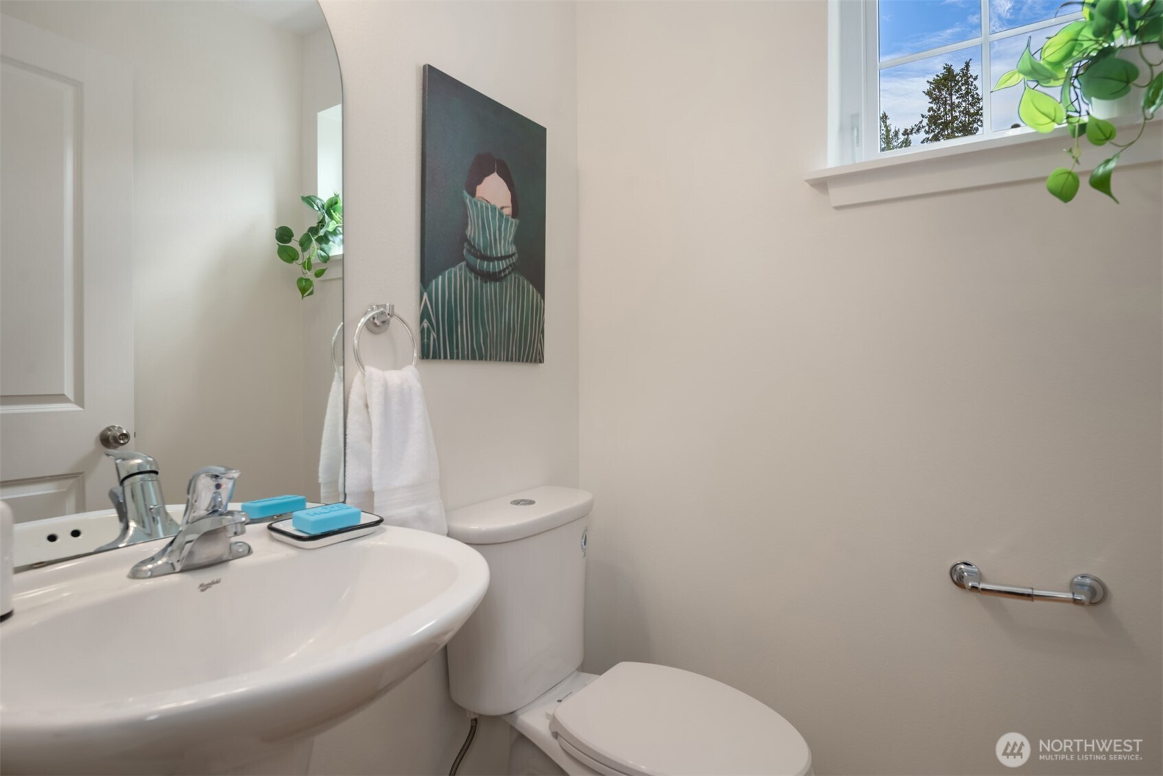 3302 West Government Way, Unit A Seattle, WA 98199 - Photo 17 of 32 a bathroom with a toilet sink and mirror