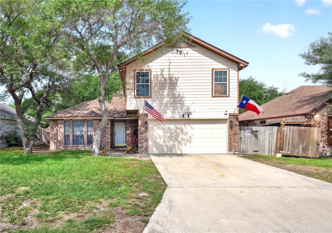 a view of a house with a yard and sitting area