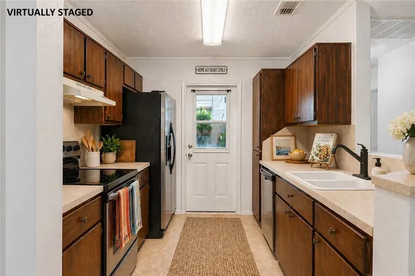 a kitchen with a sink stove and refrigerator