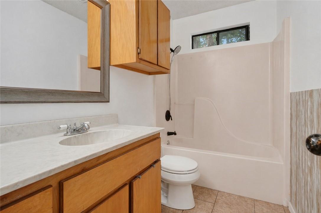 2328 Timberleaf Circle Ingleside, TX 78362 - Photo 19 of 33 a bathroom with a sink a toilet and shower