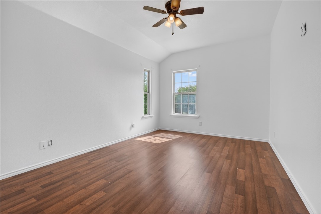 2328 Timberleaf Circle Ingleside, TX 78362 - Photo 24 of 33 an empty room with wooden floor fan and windows