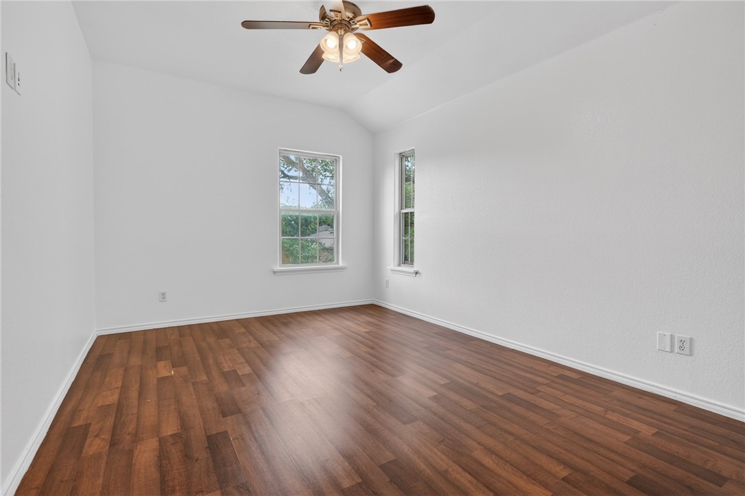 2328 Timberleaf Circle Ingleside, TX 78362 - Photo 27 of 33 an empty room with wooden floor fan and windows