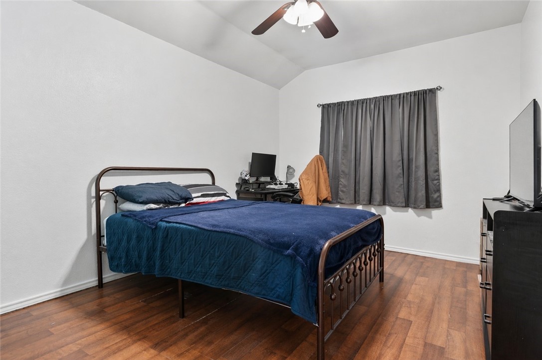 2328 Timberleaf Circle Ingleside, TX 78362 - Photo 28 of 33 a bedroom with a bed and wooden floor